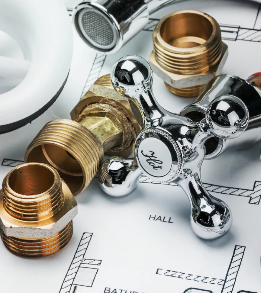 plumbing tools and a blueprint